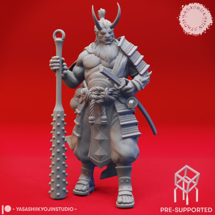 a statue of a demon holding a staff